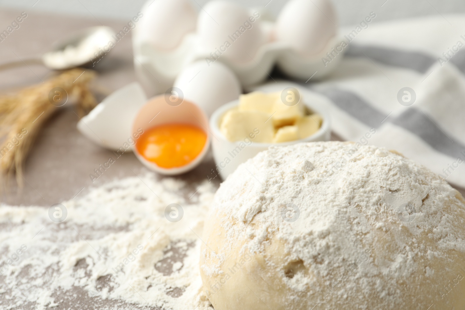 Photo of Wheat dough and products on table, closeup view with space for text. Cooking pastries