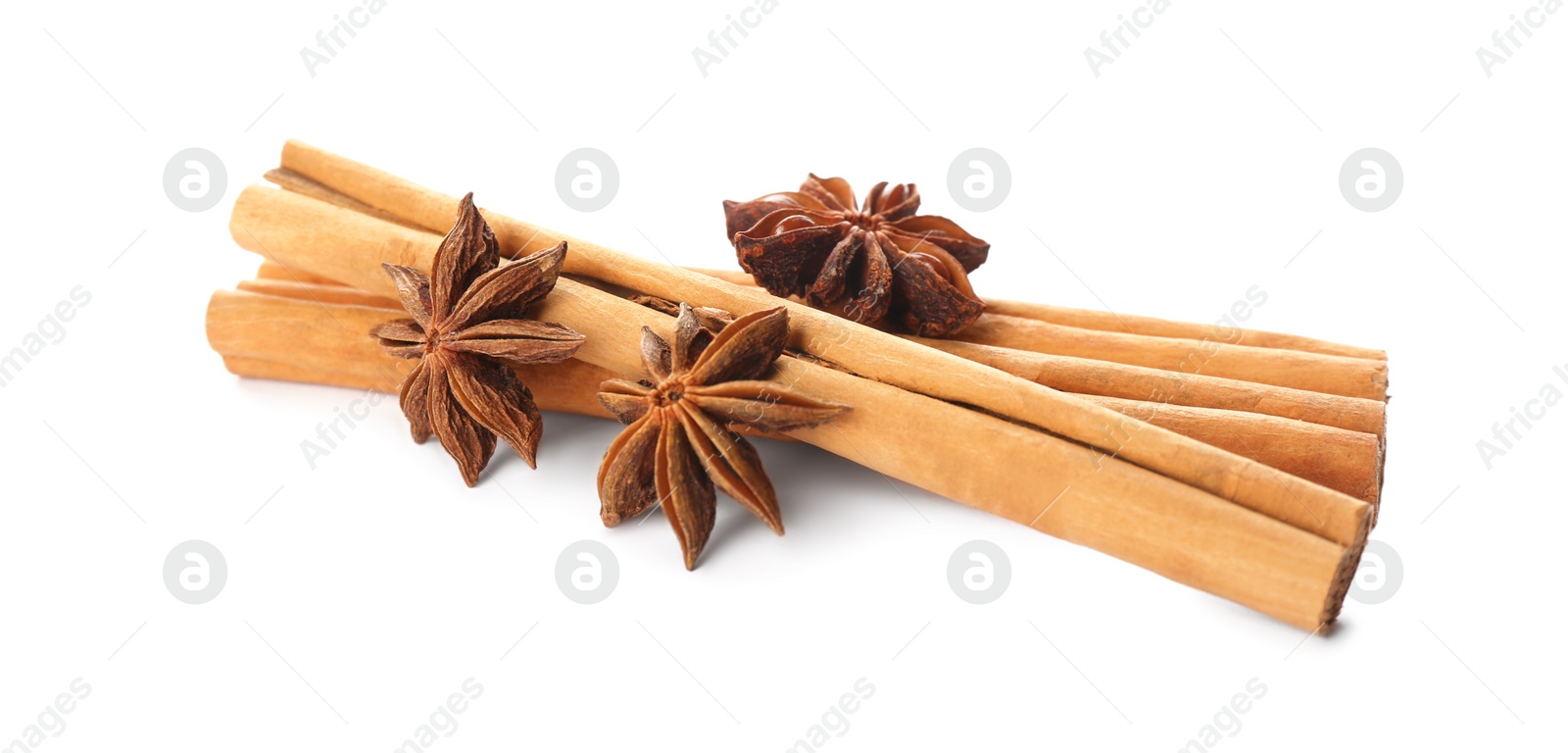 Photo of Aromatic cinnamon sticks and anise isolated on white