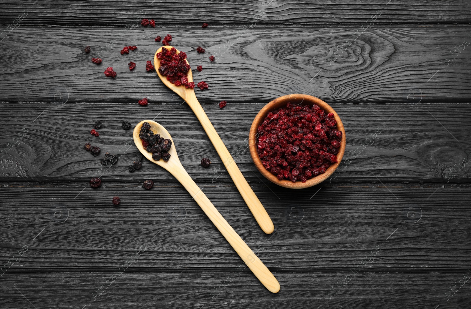 Photo of Dried black and red currant berries on wooden table, flat lay