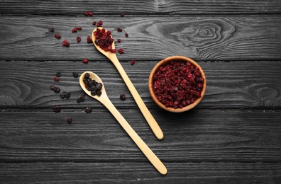 Photo of Dried black and red currant berries on wooden table, flat lay