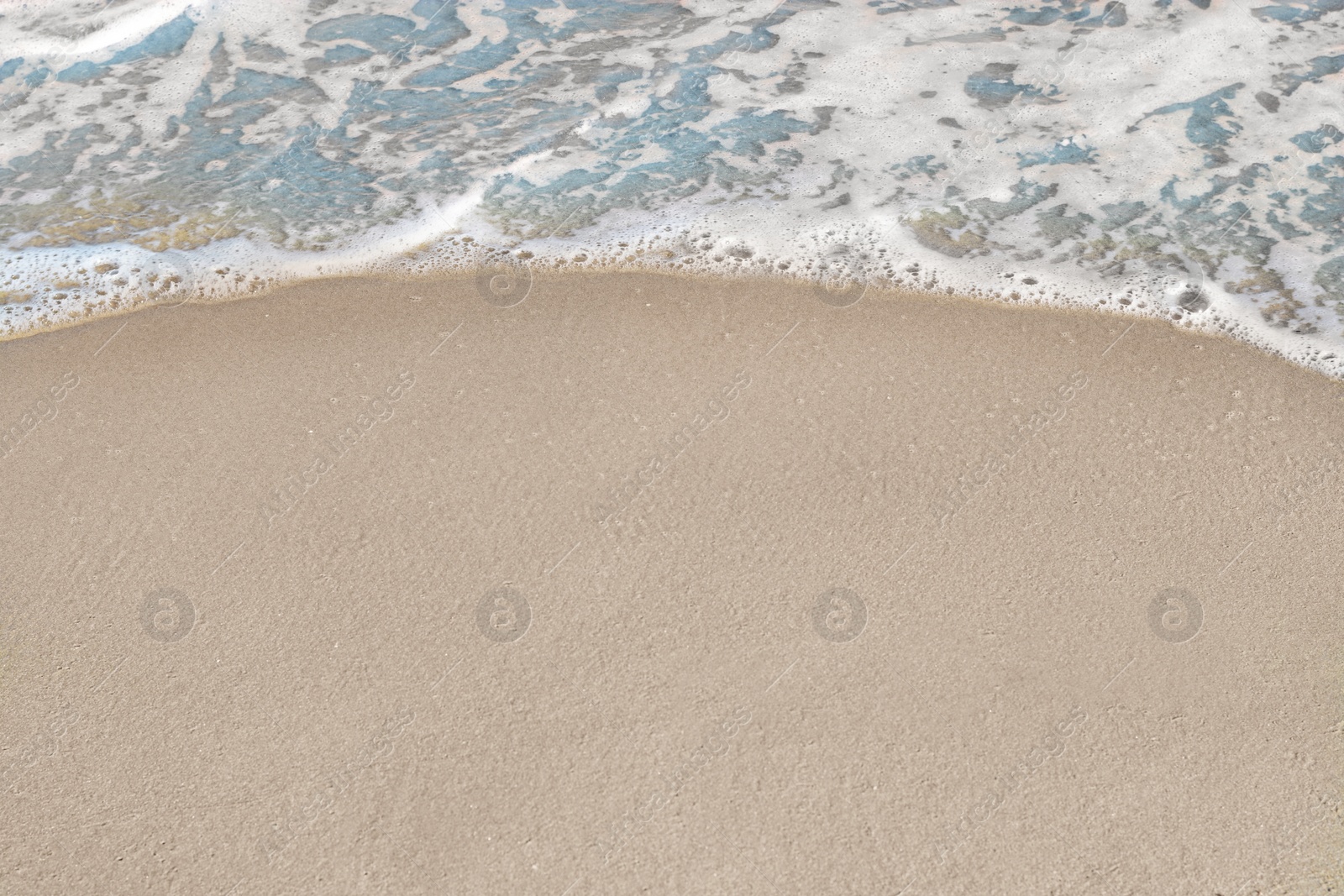 Photo of Beautiful foamy sea tide on sandy beach