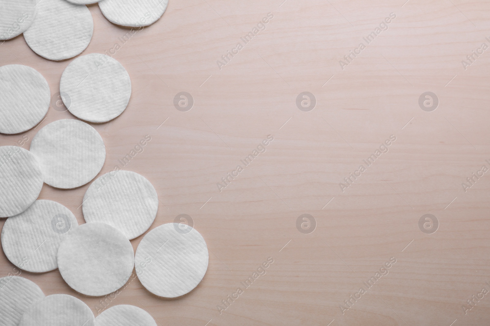 Photo of Many clean cotton pads on wooden table, flat lay. Space for text