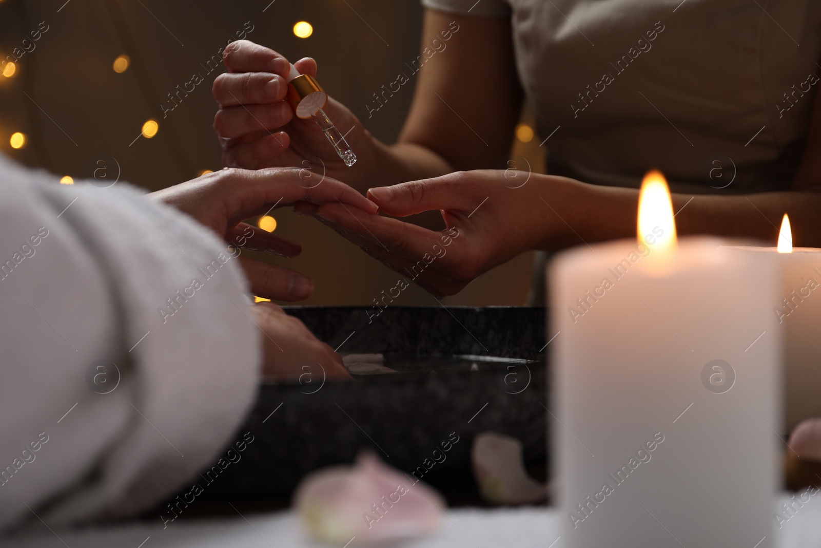 Photo of Woman receiving hand treatment in spa, closeup