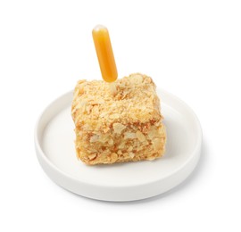 Piece of Napoleon cake with jam pipette on white background