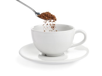 Pouring aromatic instant coffee into cup on white background