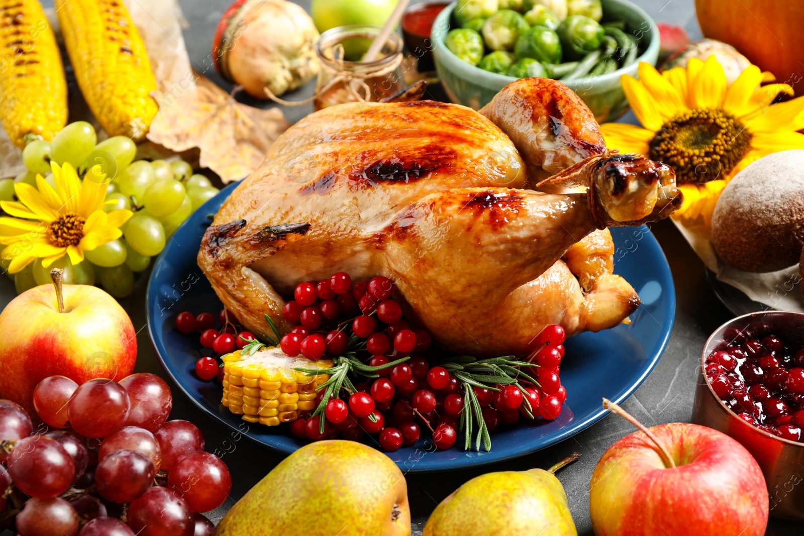 Photo of Composition with delicious turkey on grey background. Happy Thanksgiving day