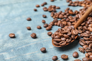 Spoon and coffee beans on wooden table