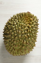 Photo of Ripe durian on white wooden table, top view