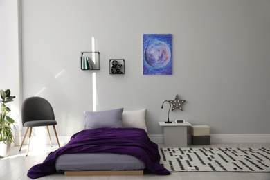 Photo of Modern teenager's room interior with comfortable bed and stylish design elements