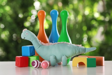 Set of different toys on table against blurred background