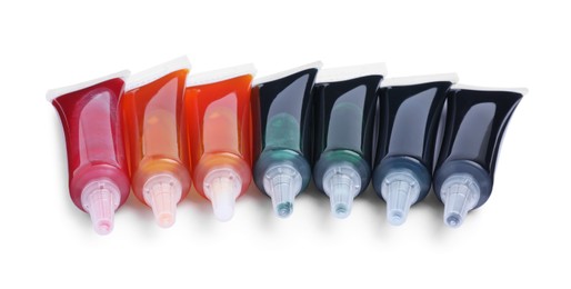 Tubes with different food coloring on white background