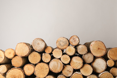 Photo of Cut firewood on grey background. Heating in winter