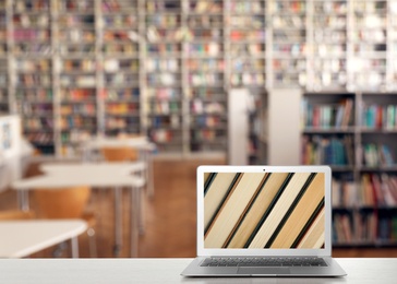Image of Digital library concept. Modern laptop on table indoors, space for text