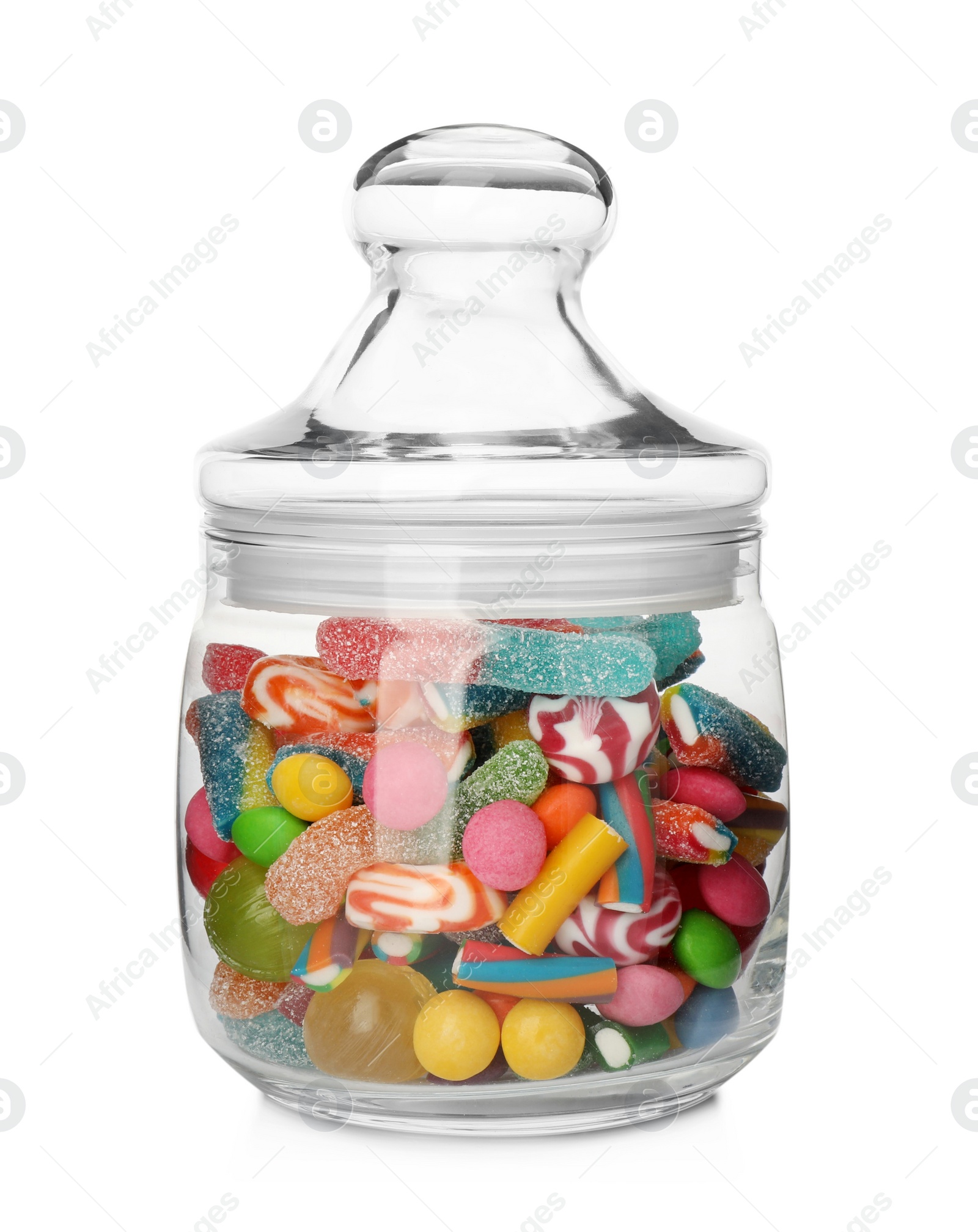 Photo of Many different candies in glass jar isolated on white