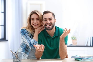 Happy couple using video chat for conversation indoors