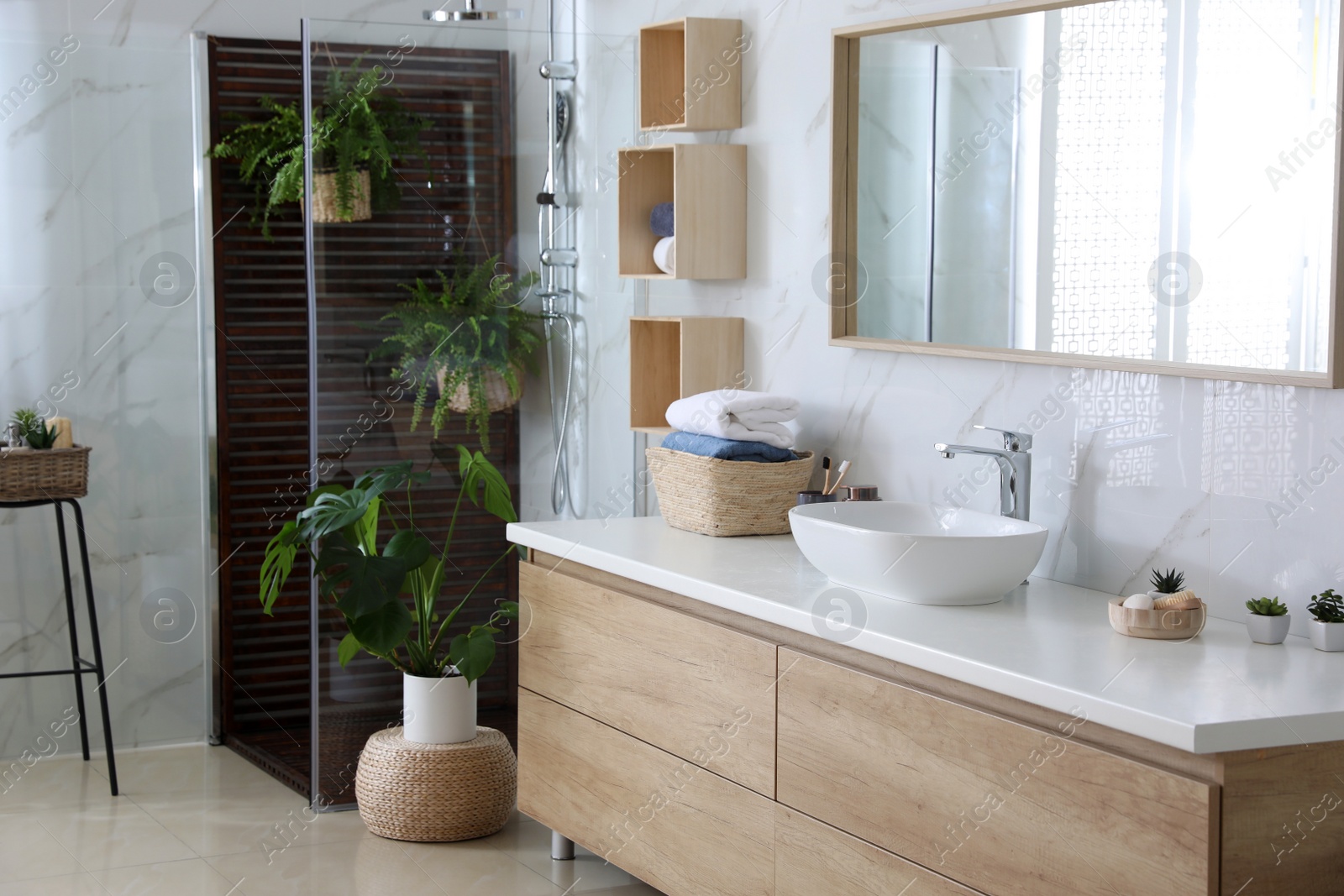 Photo of Bathroom interior with shower stall, counter and houseplants. Idea for design