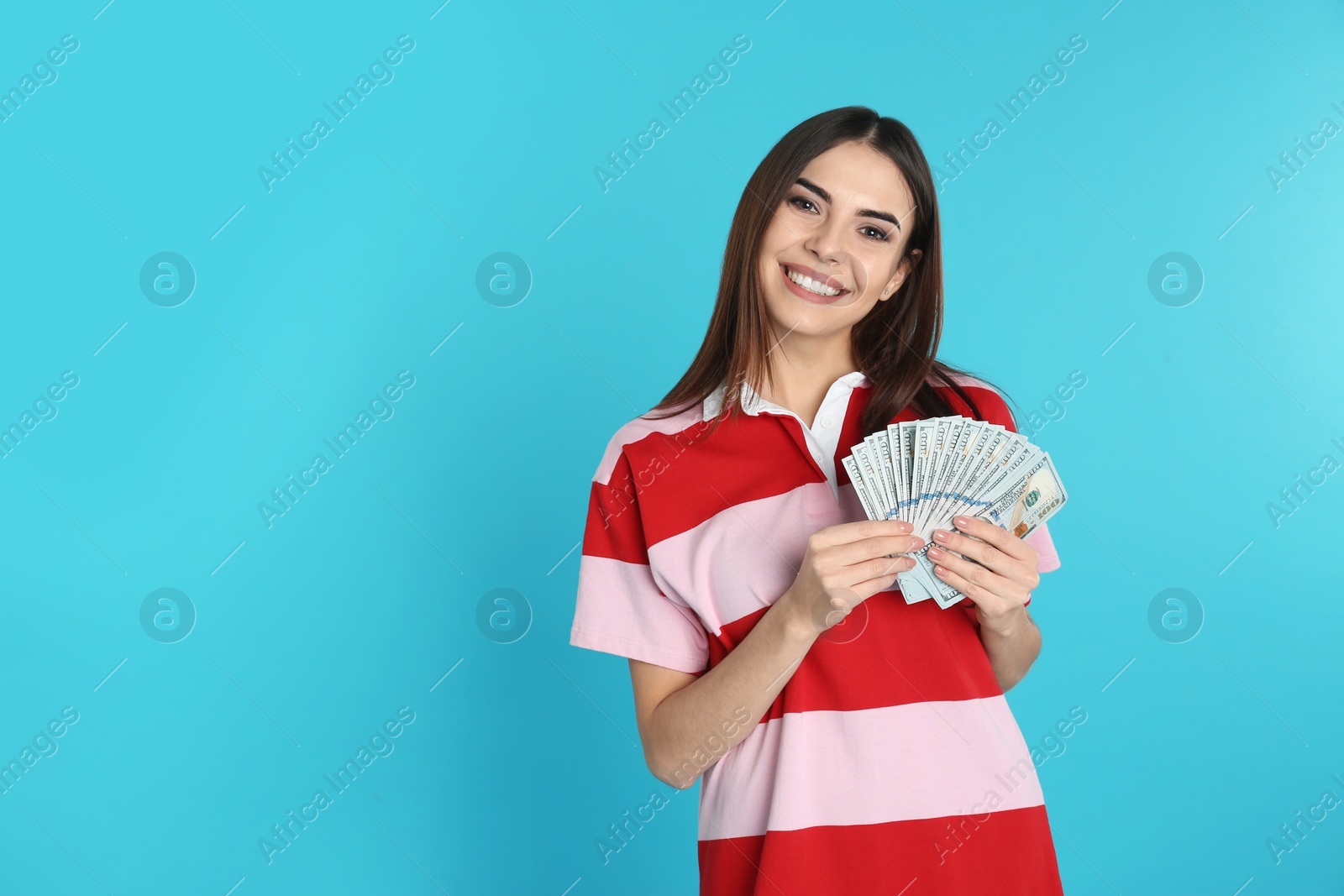 Photo of Young woman with money on color background. Space for text