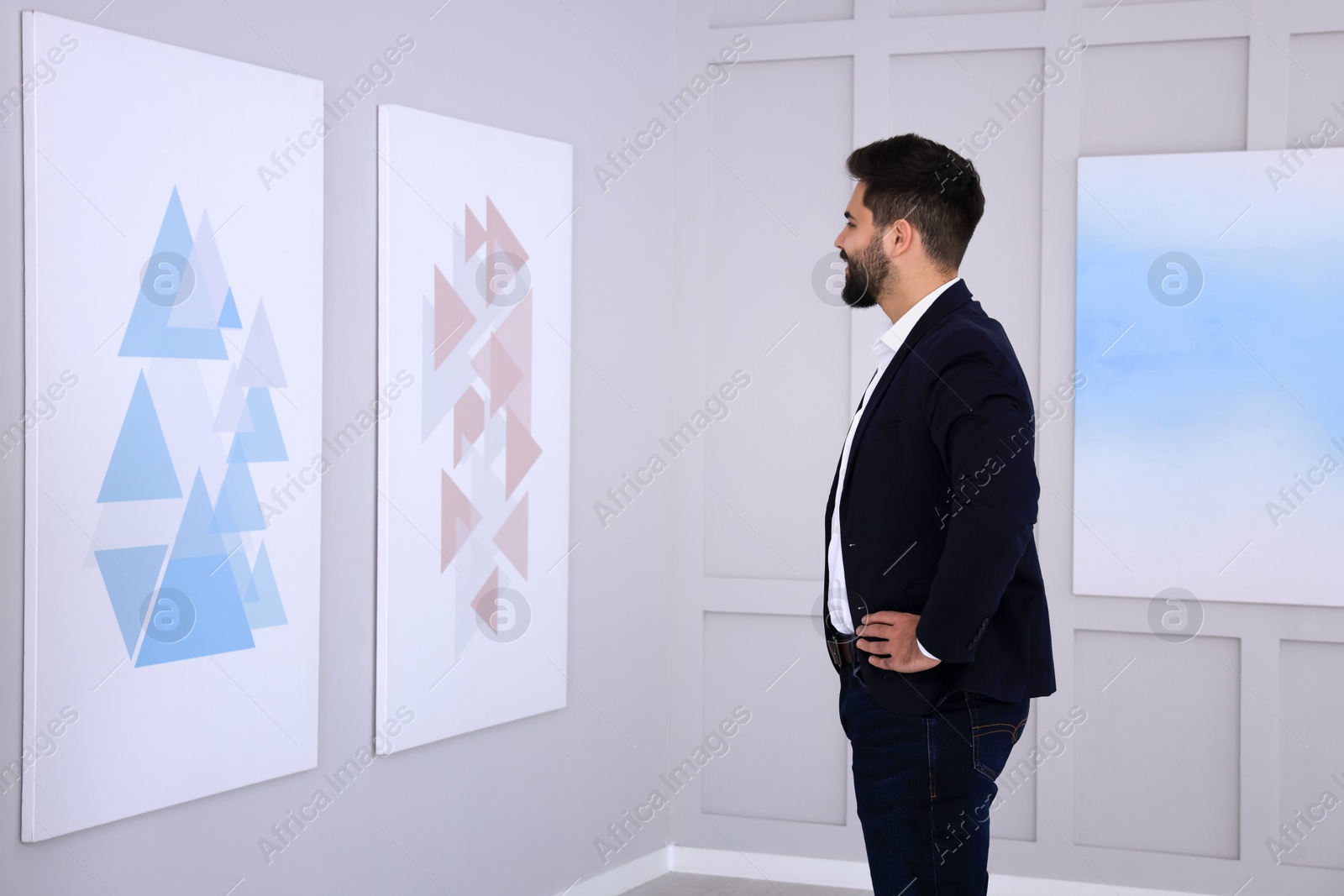 Photo of Young man at exhibition in art gallery