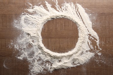 Photo of Imprint of plate on wooden table with flour, top view