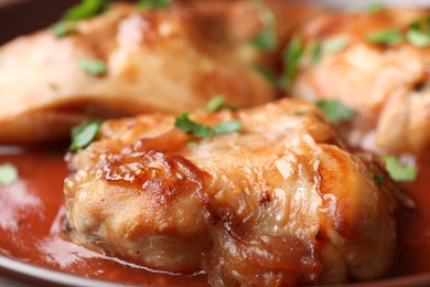 Photo of Tasty cooked rabbit meat with sauce and parsley, closeup