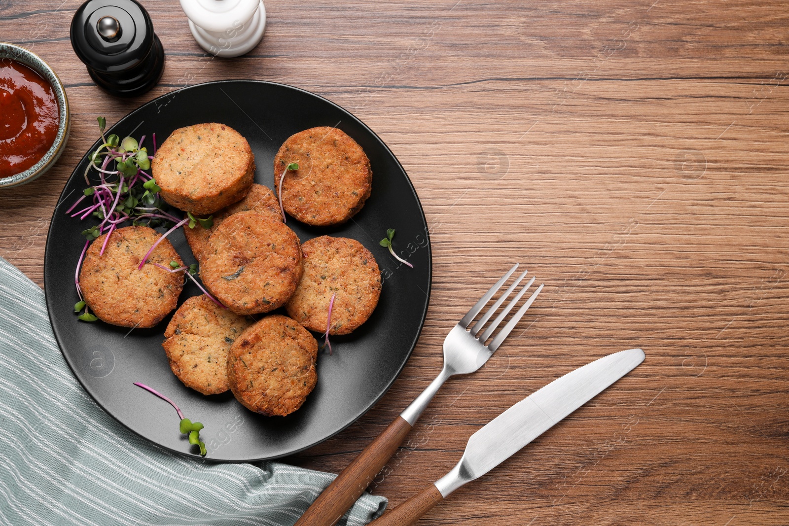 Photo of Delicious vegan cutlets served on wooden table, flat lay. Space for text