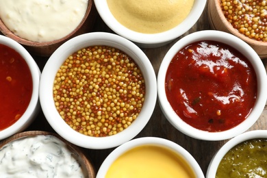 Set of different delicious sauces as background, closeup