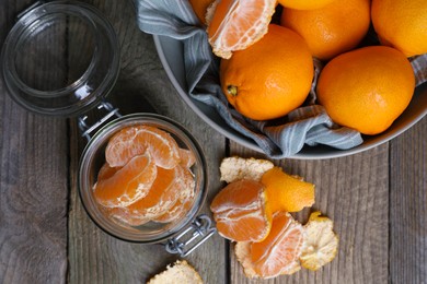 Photo of Many fresh ripe tangerines on wooden table, flat lay