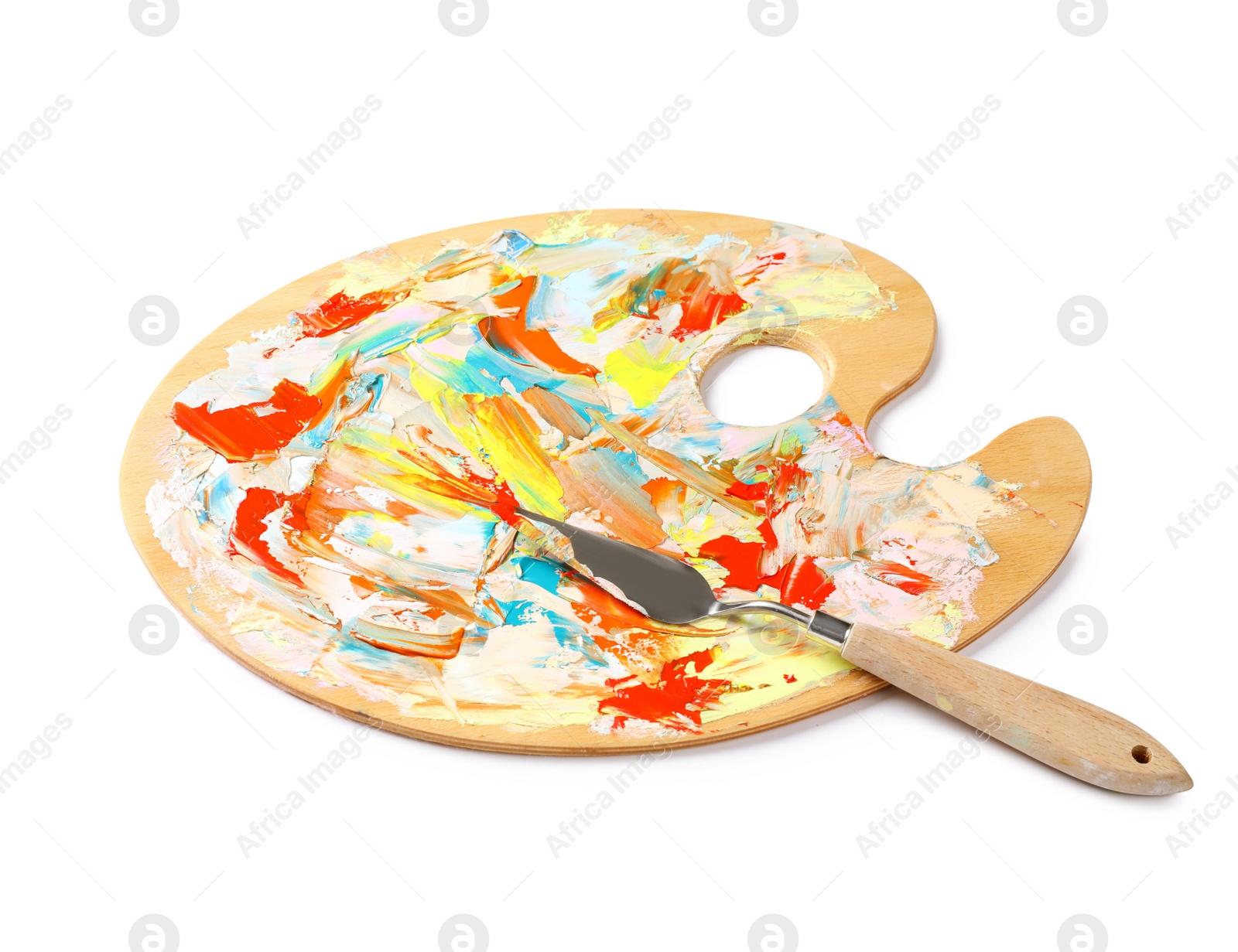 Photo of Dirty wooden artist's palette with painting knife isolated on white