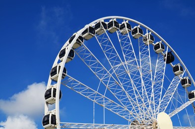 Photo of Beautiful large Ferris wheel against blue sky