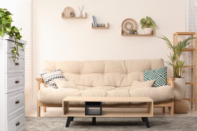 Photo of Stylish living room interior with comfortable sofa and side table