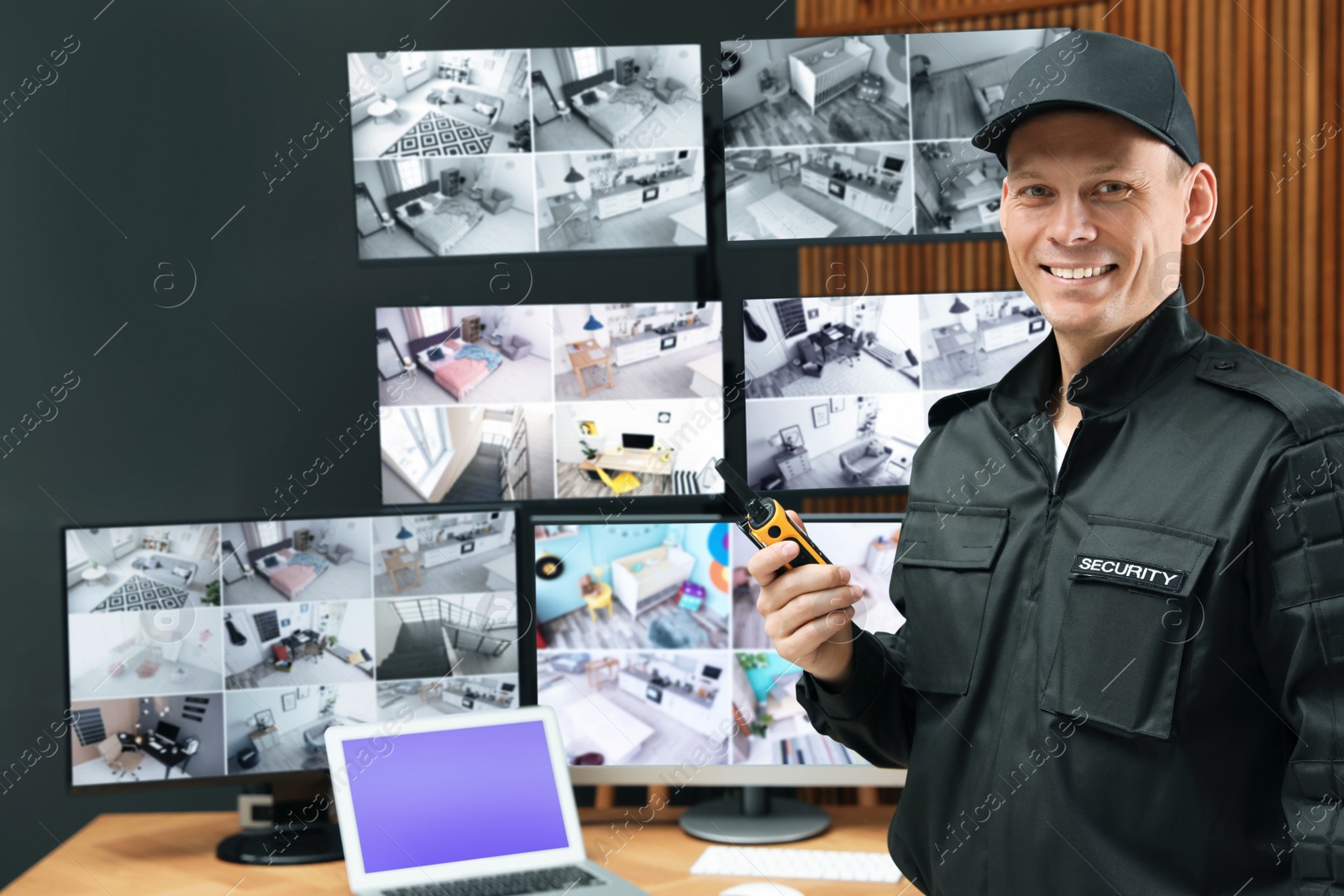 Photo of Security guard with portable transmitter at workplace in office