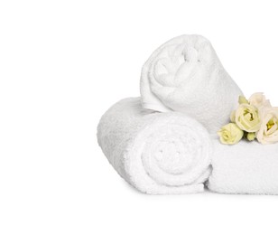 Photo of Soft terry towels with beautiful flowers on white background