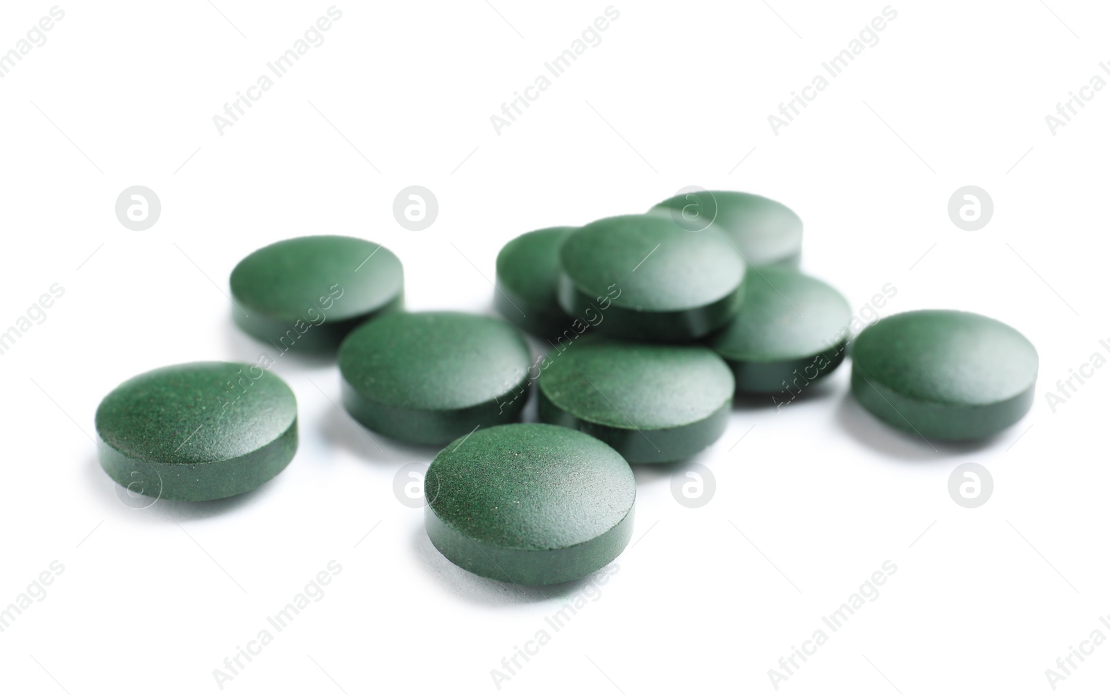 Photo of Spirulina tablets on white background. Healthy lifestyle