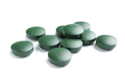 Photo of Spirulina tablets on white background. Healthy lifestyle