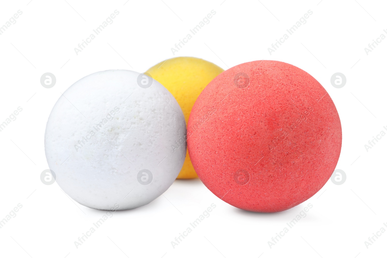 Photo of Three colorful bath bombs on white background