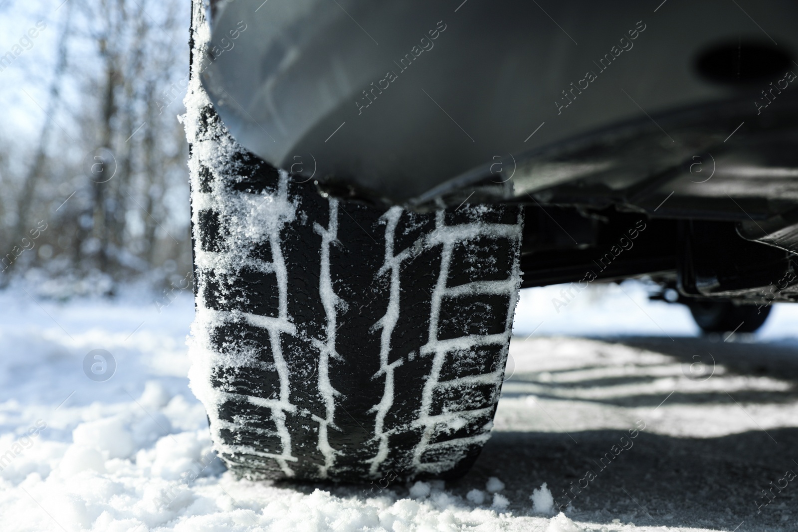 Photo of Car with winter tires on snowy road, closeup view