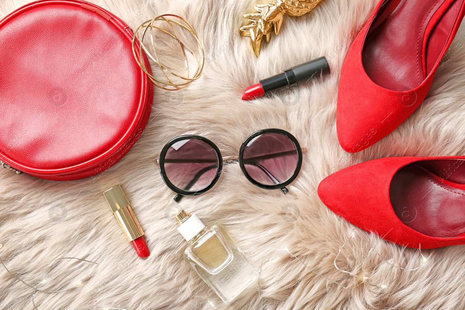 Photo of Flat lay composition with cosmetics and stylish accessories on fur