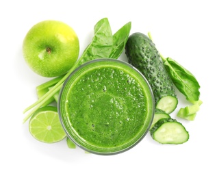 Photo of Green juice and fresh ingredients on white background, top view