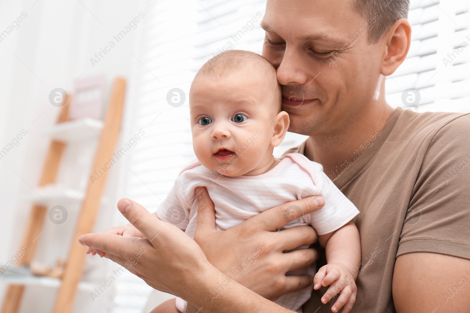 Photo of Happy father with his little baby at home