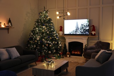 Cozy living room interior with beautiful Christmas tree near fireplace