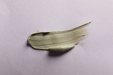 Photo of Sample of face cream on lilac background, top view