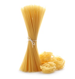 Photo of Uncooked fettuccine pasta and spaghetti on white background