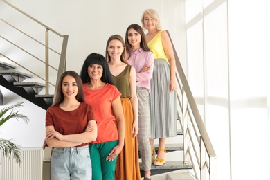 Photo of Group of ladies on stairs indoors. Women power