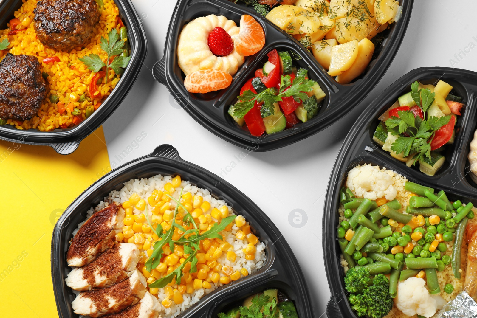 Photo of Lunchboxes with different meals on color table, flat lay. Healthy food delivery