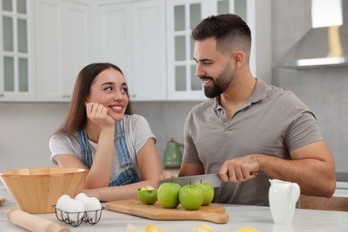 Photo of Happy young couple spending time together in kitchen