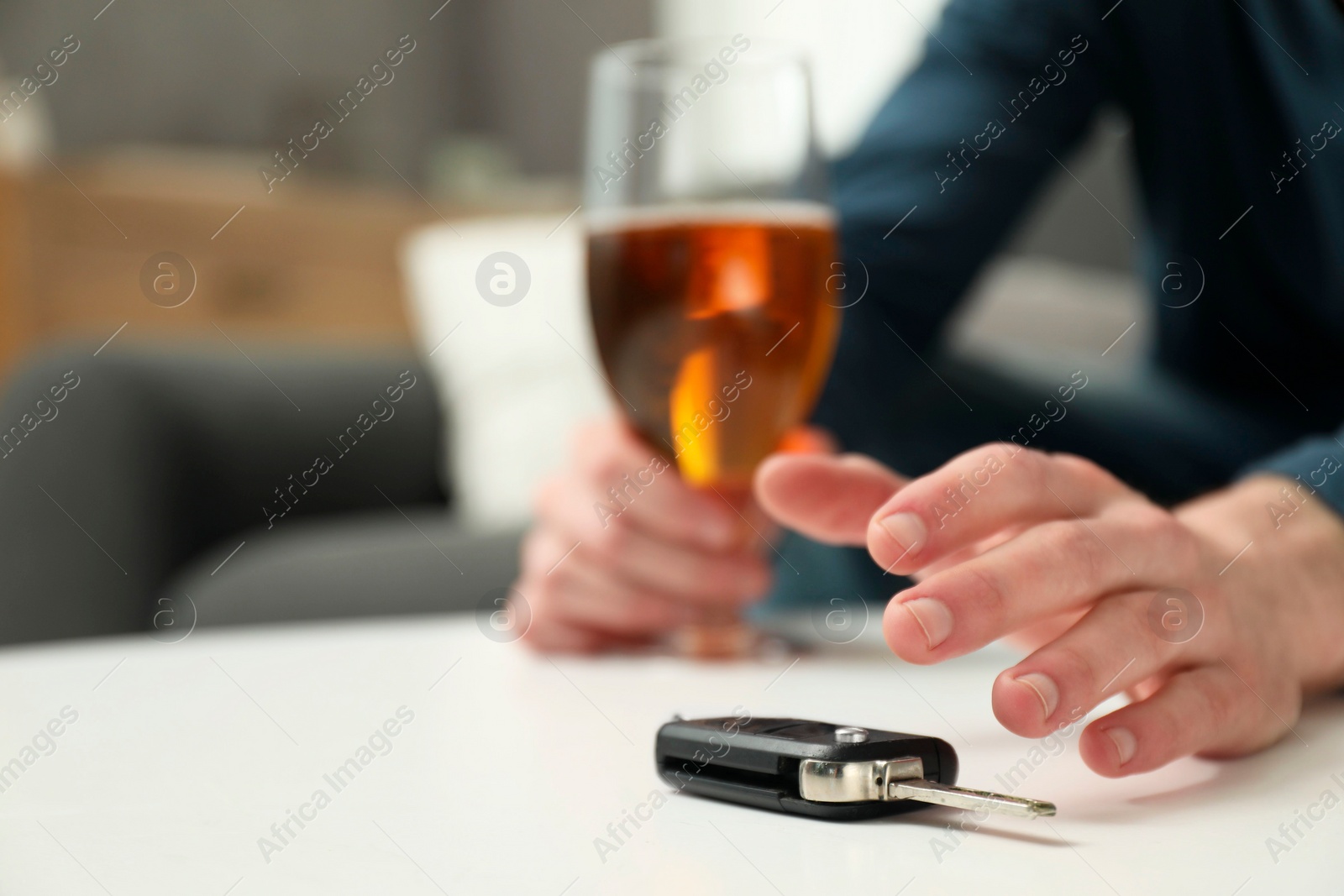 Photo of Drunk man reaching for car keys indoors, closeup. Space for text