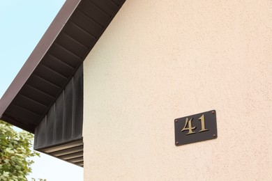 Photo of Plate with house number 41 on textured wall outdoors