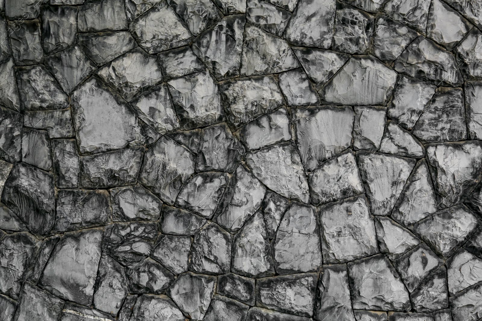 Photo of Texture of grey stone wall as background