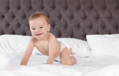 Photo of Adorable little baby on bed at home