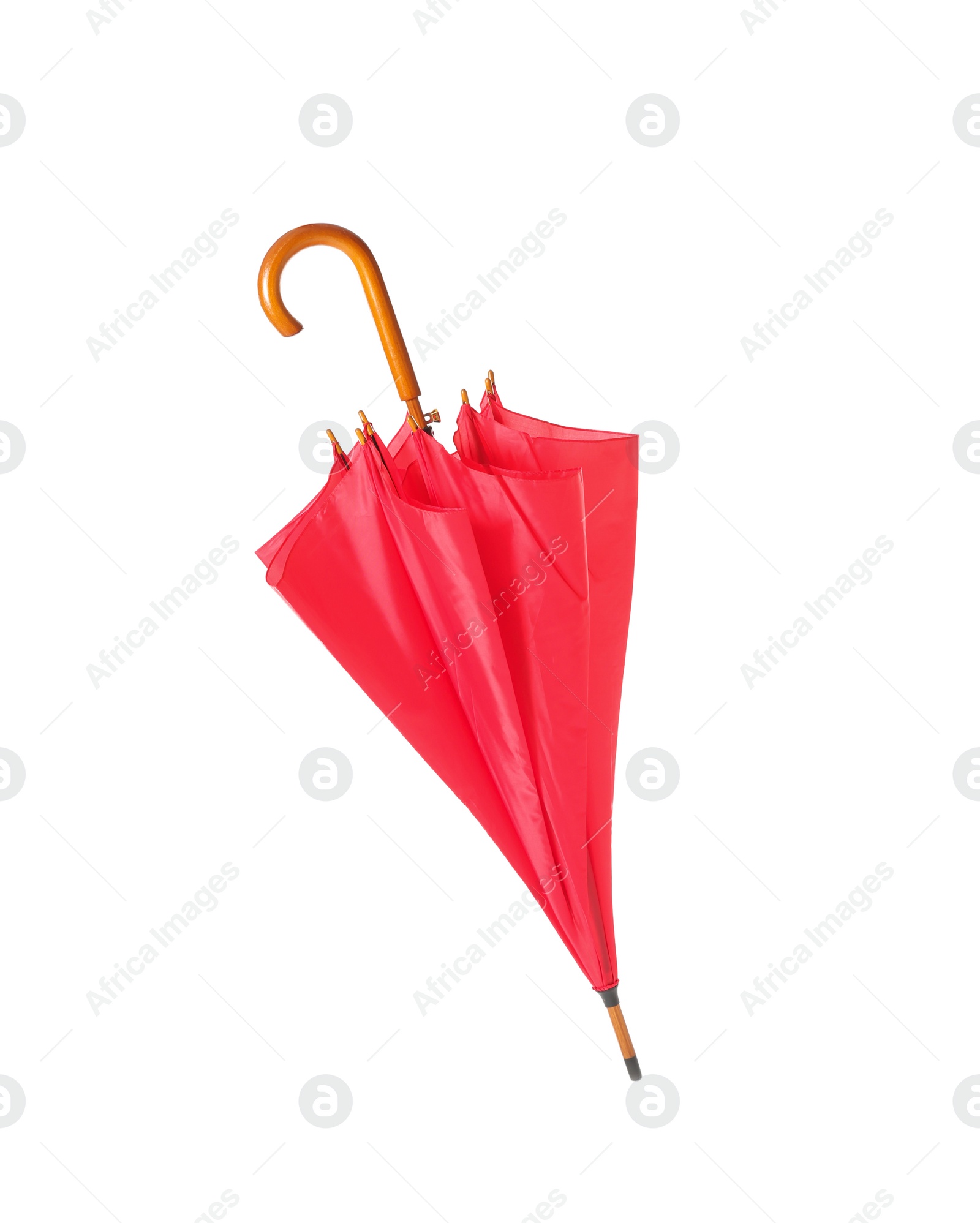 Photo of Modern closed red umbrella isolated on white